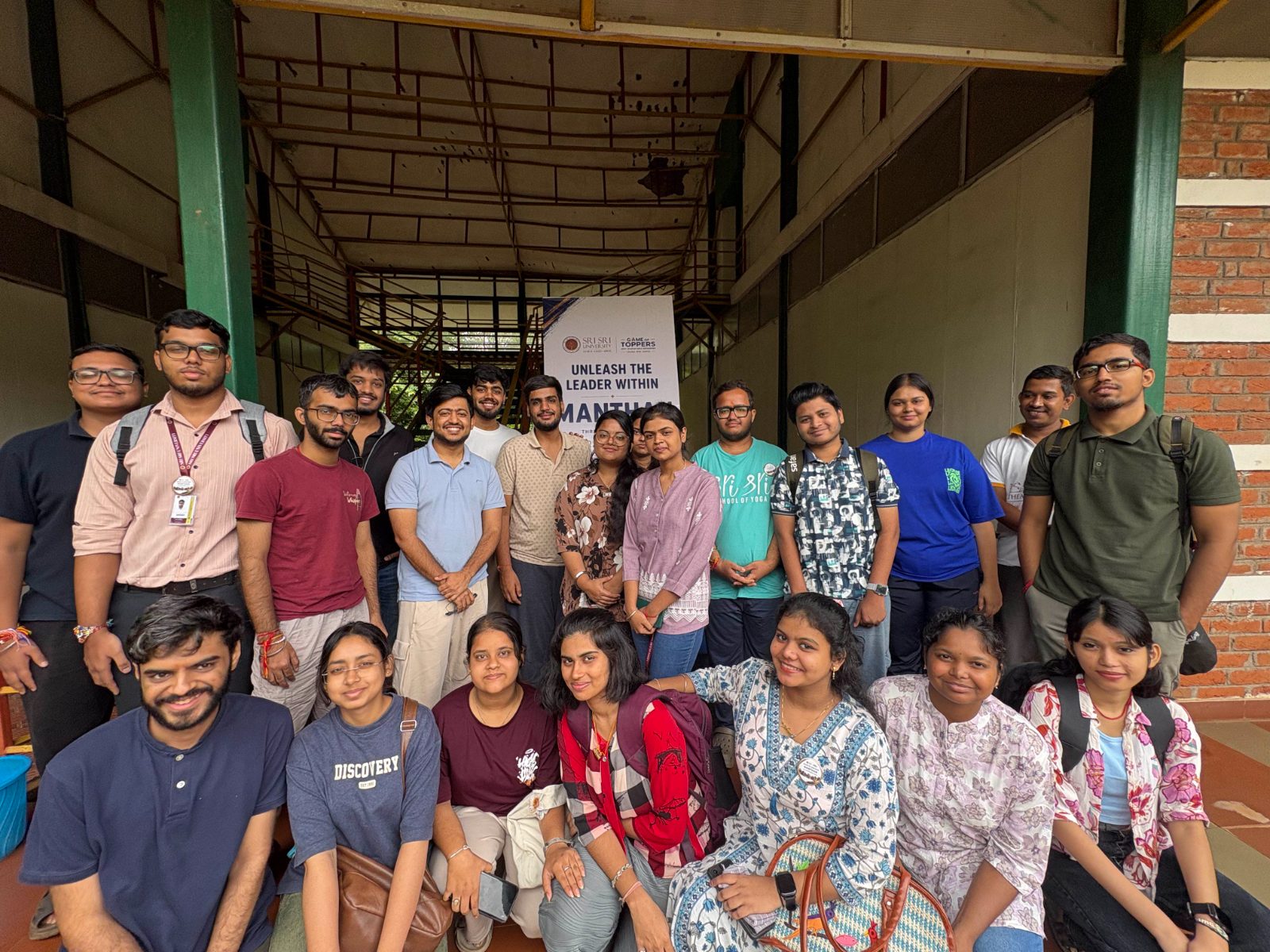Manthan cohort gathered outdoors beside the programme banner