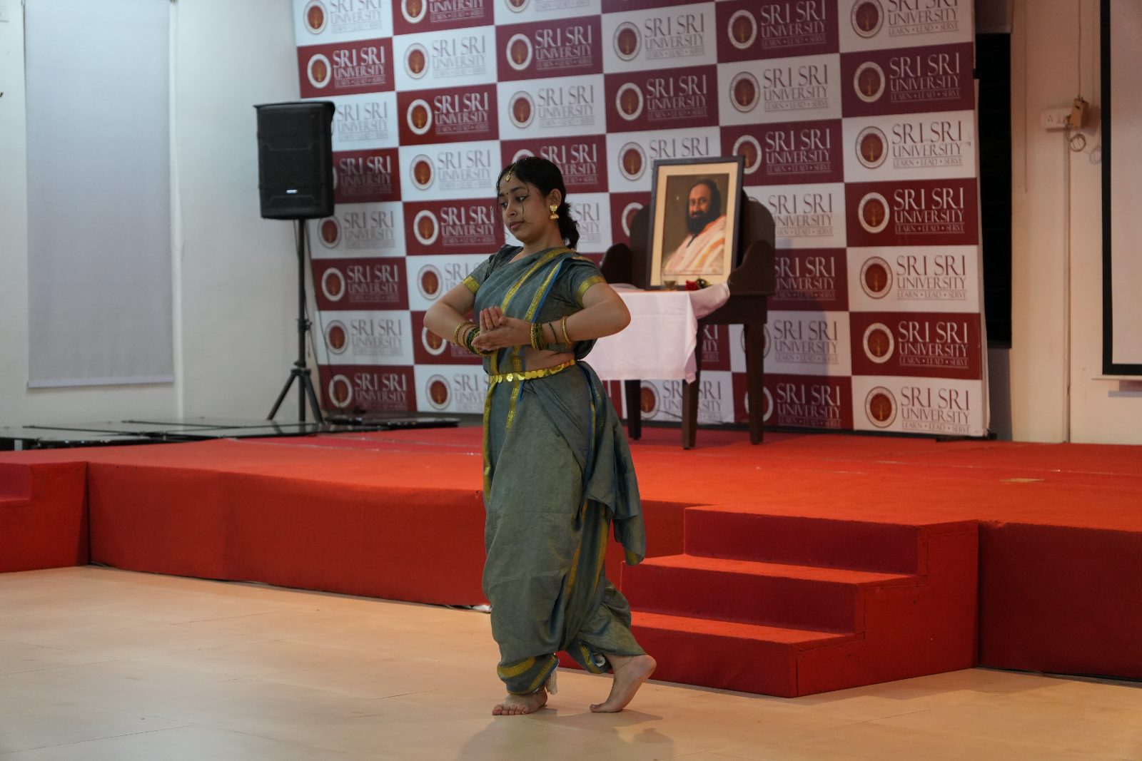 A participant performing a classical dance piece on stage